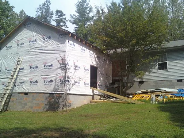 Tyvek wrapped gable on a new room addition beside an existing home in Franklin Park